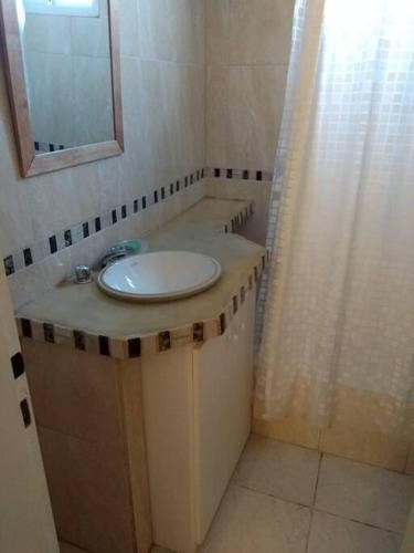 a bathroom with a sink and a mirror at Moana II in Las Grutas