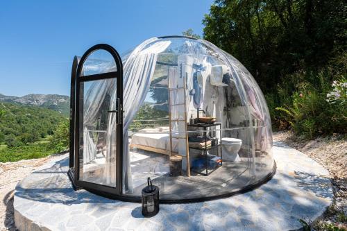 a glass dome with a mirror on a rock at ZEN Relaxing Village in Cetinje