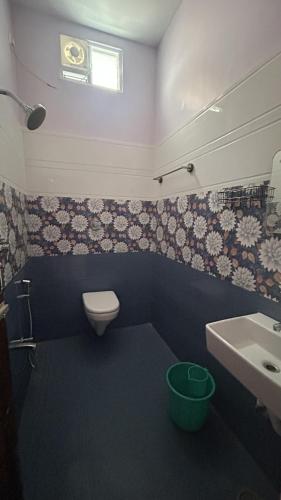 a bathroom with a white toilet and a sink at Breeze valley Residency in Yelagiri