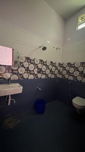 a bathroom with a sink and a toilet at Breeze valley Residency in Yelagiri