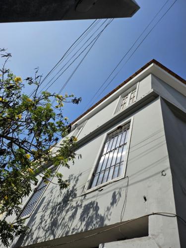 a white building with windows on top of it at Departamento en el Centro Historico de Lima Perú in Lima