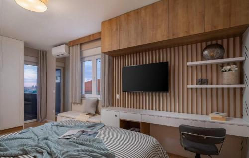 a bedroom with a bed and a television on a wall at Villa Katarina Privlaka in Privlaka