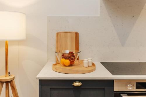 a kitchen counter with a bowl of fruit on a cutting board at Cart Shed 2 in Nuneham Courtenay