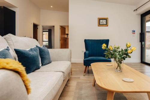 a living room with a couch and a table at Cart Shed 2 in Nuneham Courtenay