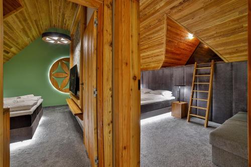 a bedroom with a bunk bed and a ladder at Czorsztyn Prestige Osada in Czorsztyn
