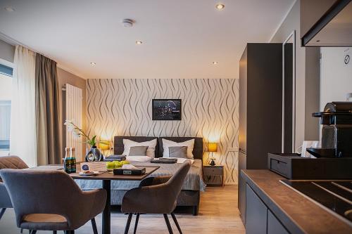 a hotel room with a bed and a table and chairs at LiRo Hotel-Pension Haus Andrea in Niederkrüchten