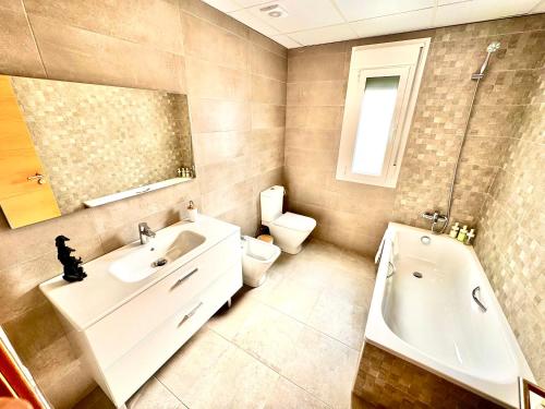 a bathroom with a sink and a tub and a toilet at Golf villa heated pool relax tenerife south in San Miguel de Abona