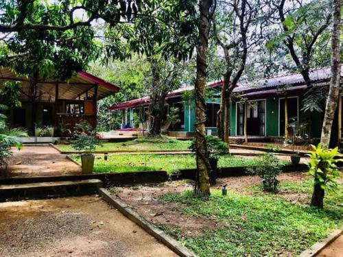 a house with trees in front of it at GreenSenz Resort & Hostel-Sigiriya in Sigiriya