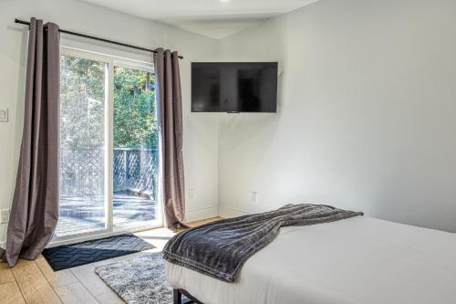 a bedroom with a bed and a large window at Modern Living Steps From Downtown in Walnut Creek