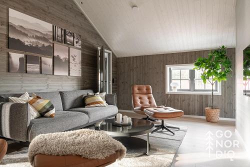 a living room with a couch and a chair at The Black Deer Lodge in Tällberg