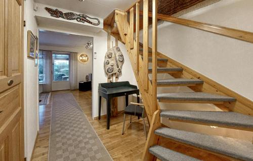 a staircase in a room with a table and a chair at 3 Bedroom Beautiful Home In Höganäs in Höganäs