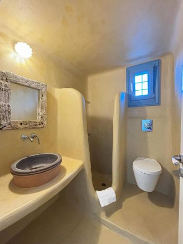 a bathroom with a sink and a toilet at Almyra Yellow Villa in Kithnos