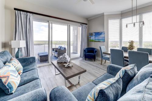 a living room with a blue couch and a table at Disney Lakefront Luxury! in Orlando