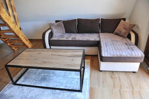 a living room with a couch and a coffee table at Androv kutak in Andrići