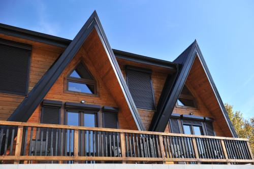 an image of a log cabin with large windows at Androv kutak in Andrići