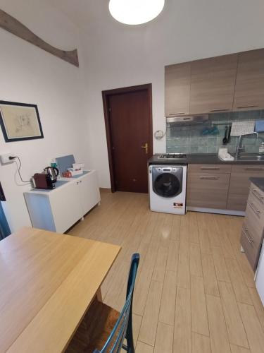 a kitchen with a table and a washing machine at Catania city center appartaments in Catania