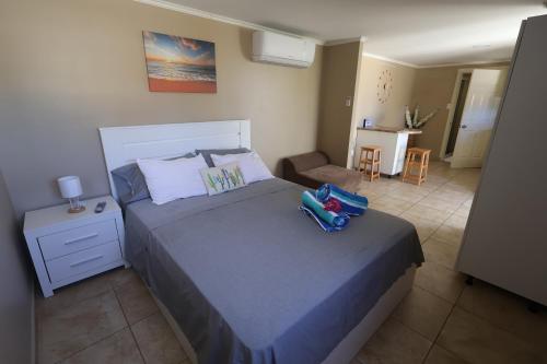 a bedroom with a bed and a chair in it at Sun and Beach Escape, one bedroom apartment. in Paradera