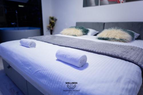 a couple of beds with towels on top of them at Heaven Heart - Apartmani Tuzla in Tuzla