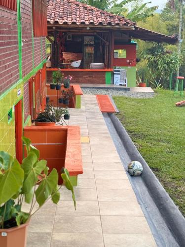 a house with a garden with benches and a building at Finca La Gaviota in Montenegro