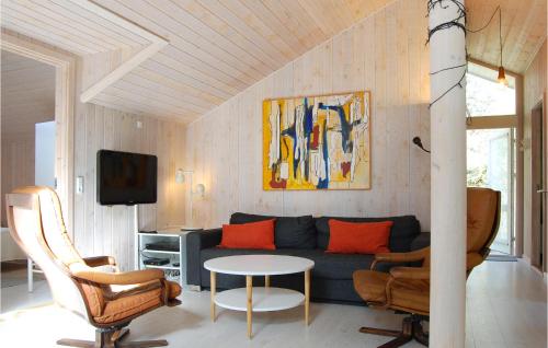 a living room with a blue couch and a table at Villa Mormor in Løkken