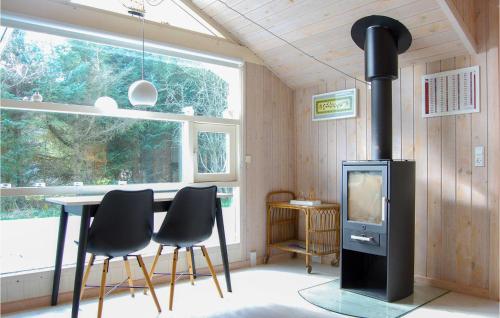 a room with a stove and a table and chairs at Villa Mormor in Løkken