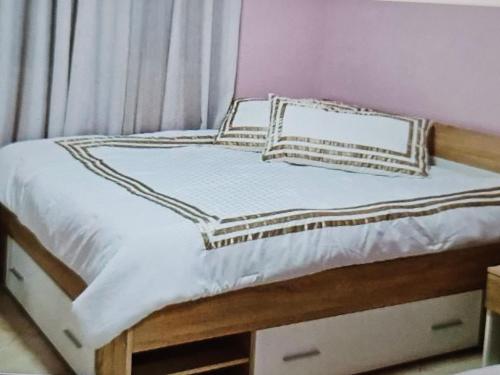 a bed with two pillows on top of it at Marea Resort in Golem