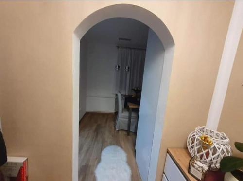 a hallway with an archway in a living room at Štýlový apartmán in Dubnica nad Váhom
