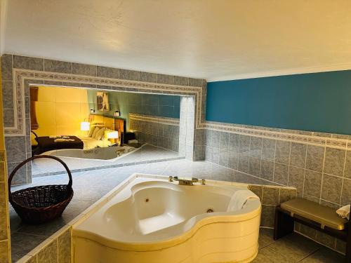 a bathroom with a large tub in a room at The Boston Inn in Westminster