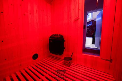 a red room with a red wall with a window at Heaven Heart - Apartmani Tuzla in Tuzla
