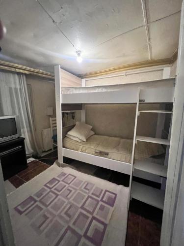 a room with two bunk beds and a television at DEDENİN YERİ İSTANBUL in Istanbul