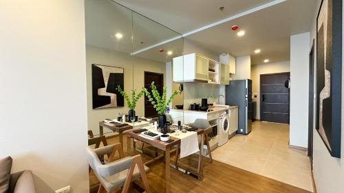 a kitchen and living room with a table and chairs at The Astra Chang Khlan Chiang Mai in Chiang Mai