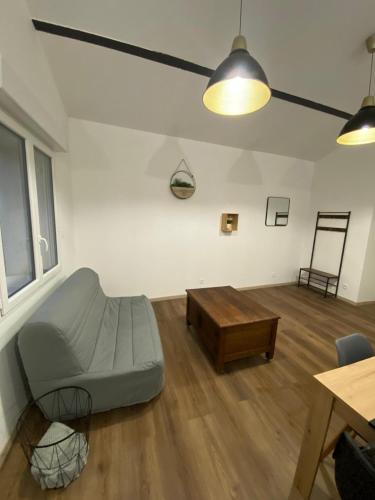 a living room with a couch and a coffee table at Gîte berclois in Bercloux