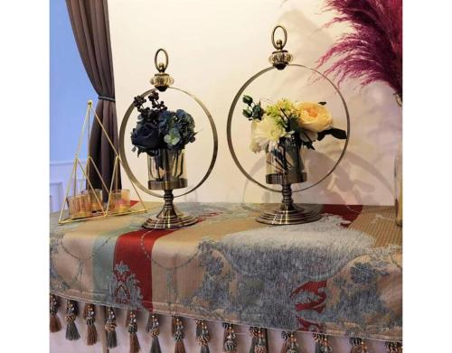 two vases on a table with flowers in them at 北欧ING风格豪华日出海景套房 Nordic ING Luxury Seaview Suite in Tanjong Tokong