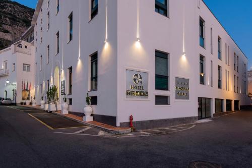 a white building with a sign on the side of it at Panorama Palace Hotel in Meta