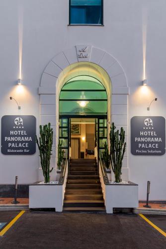 a building with a staircase in front of a building at Panorama Palace Hotel in Meta
