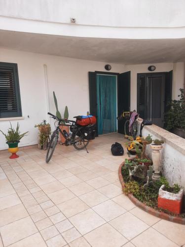 a bike parked in a room with a house at Casetta Manila in Uggiano la Chiesa