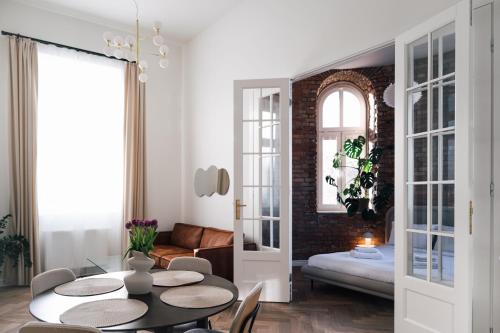 a living room with a table and chairs and a couch at Apartament Studio Migot in Przemyśl
