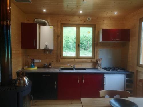 a kitchen with a sink and a window at Chalet près de Gérardmer zone Natura 2000 in Le Tholy