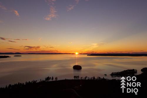 a sunset over a large body of water at The Black Deer Lodge in Tällberg