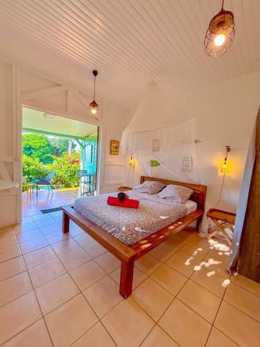 a bedroom with a bed in a room at Bwa Lélé in Sainte-Luce