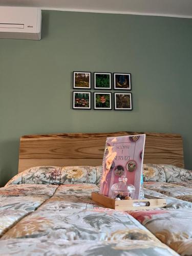 a bed with a book sitting on top of it at Il Bosco Incantato in Borgo San Dalmazzo