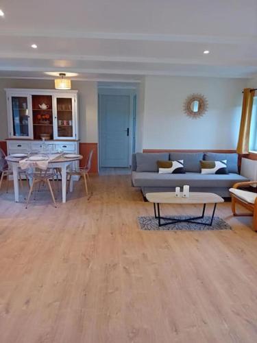 a living room with a couch and a table at Gîte La Petite Roche in Arthon