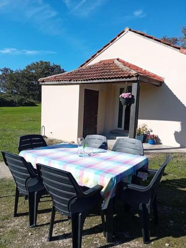 a table and chairs in front of a house at Gîte La Petite Roche in Arthon