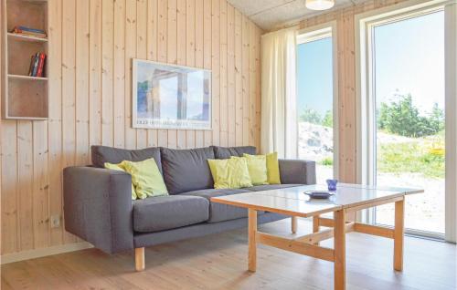 a living room with a couch and a coffee table at Holiday Home Ringkobing Xliv in Klegod