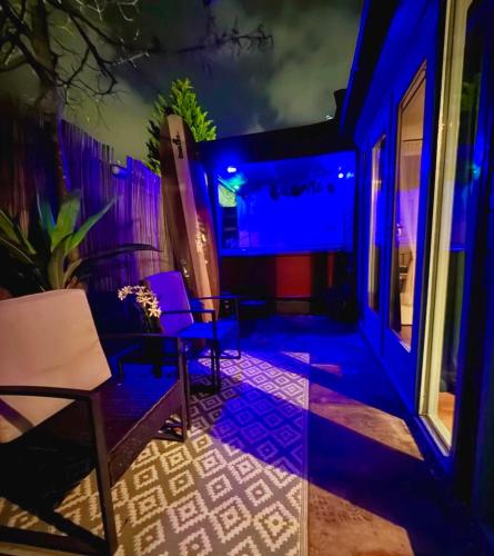 a room with two chairs and a table on a patio at Cozy comfortable house with jacuzzi & private garden near Amsterdam in Vijfhuizen