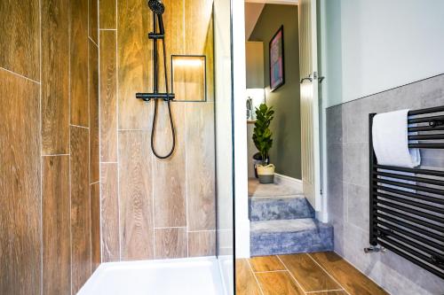a bathroom with a shower and a walk in shower at Studio 44 - Spacious Studios - City Centre Location - Contractor Friendly - Free WiFi - Smart TV - Desk Space - Well Designed - Communal Garden in Peterborough