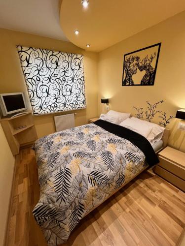 a bedroom with a large bed and a wall at Apartament Dona, Topazowa 4 in Lublin