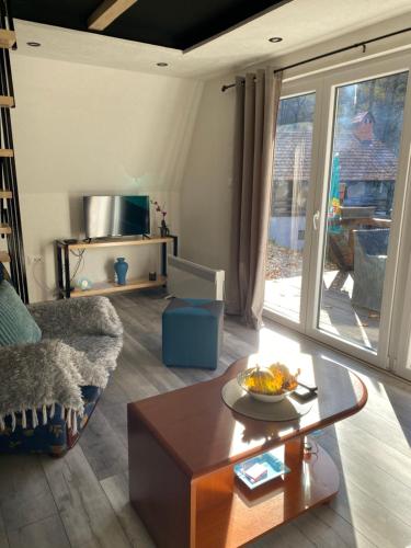 a living room with a couch and a coffee table at Planinska vila KTM Lisine in Despotovac