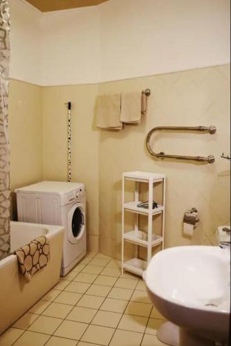 a bathroom with a washing machine and a washer at Lux-Apartment in Medieval Part of Old Riga in Riga