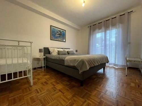 a bedroom with a bed and a large window at Holidays Vista Mar Nazare in Nazaré